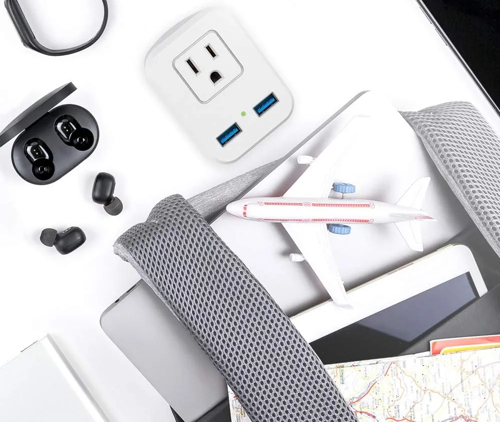 SOKOO UK plug adapter packed with earbuds and a backpack