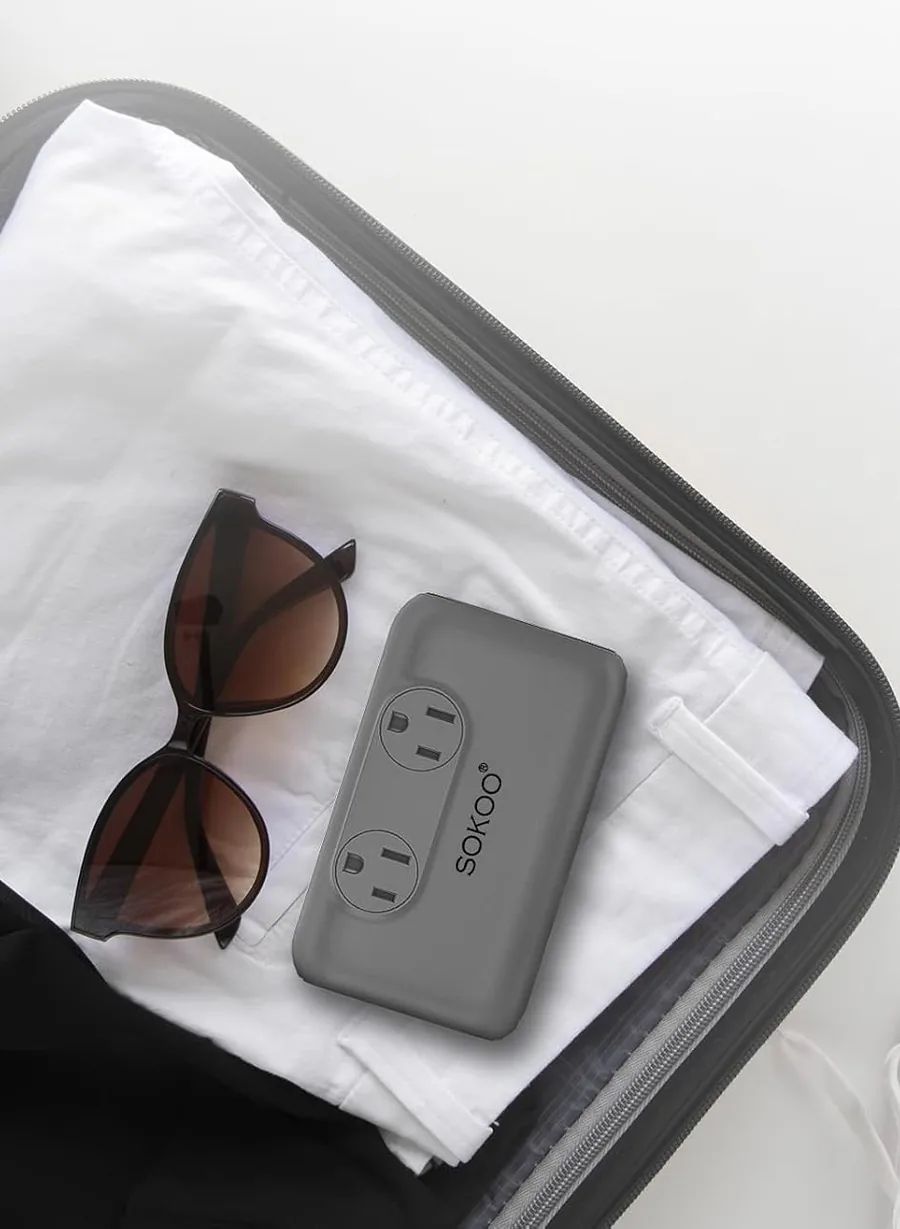 SOKOO compact converter packed in a suitcase next to sunglasses